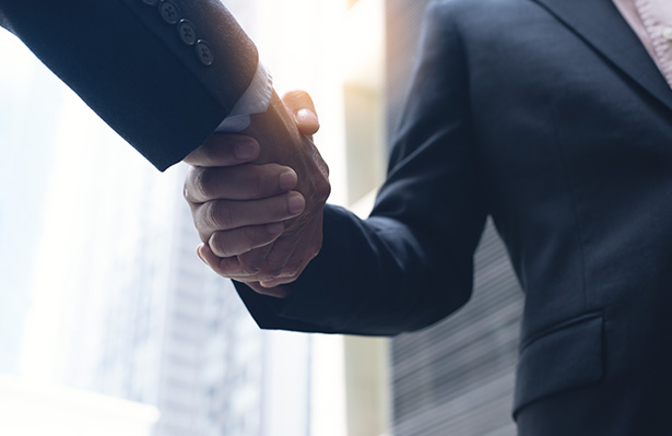 Businessmen making handshake in the city business etiquette