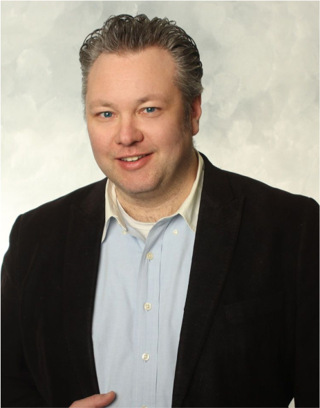 Professional portrait photograph of Warren Polson in dark suit jacket with light shirt