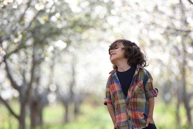 young boy with dark hair outside