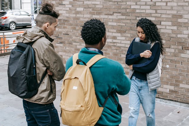 woman being harassed by two people