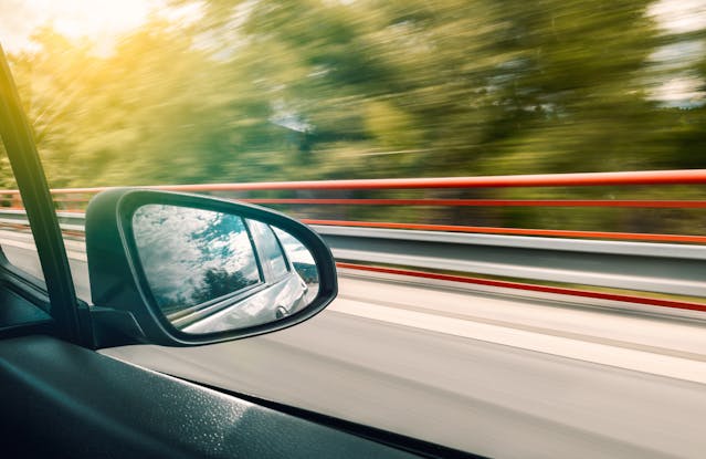 car speeding with window open