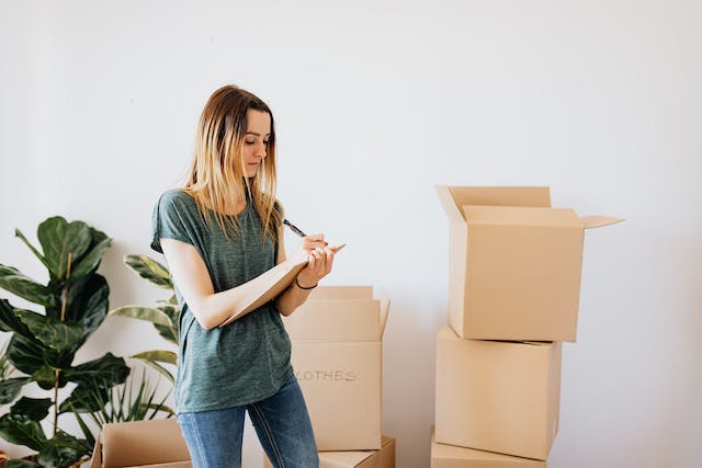 woman standing near moving boxes