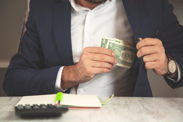 man hand money on pocket in office