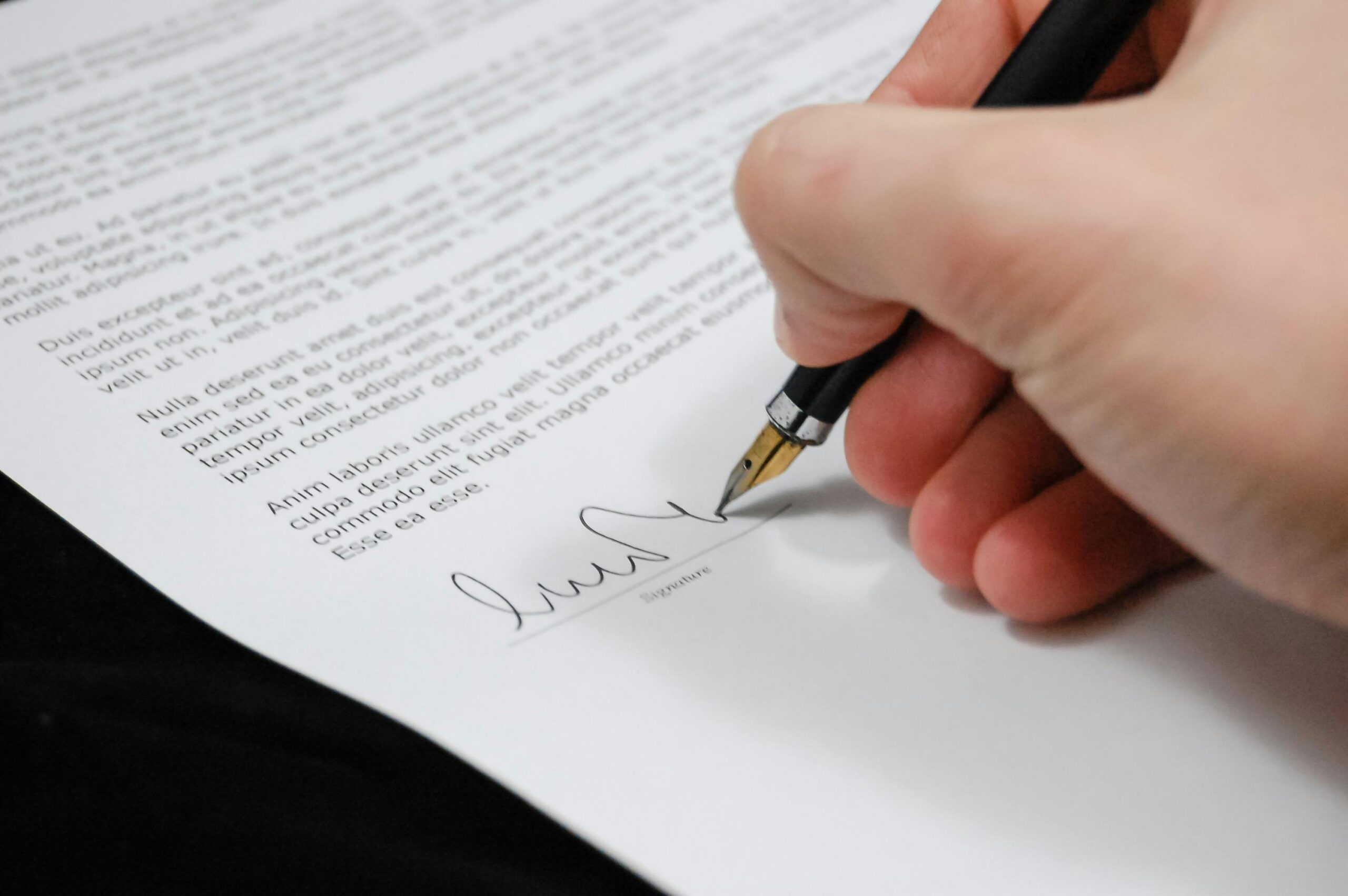 person signing paper